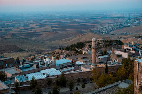 Landscape with Agricultural Fields and Rooftops with a Minaret