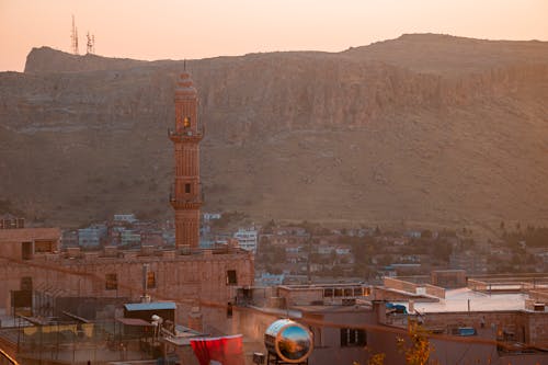 Cliff and a Townsacape with a Minaret in the Morning Mist