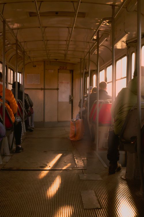 Free Passengers seated in a tram in Krivoy Rog, Ukraine, during a quiet morning commute with soft sunlight filtering in. Stock Photo