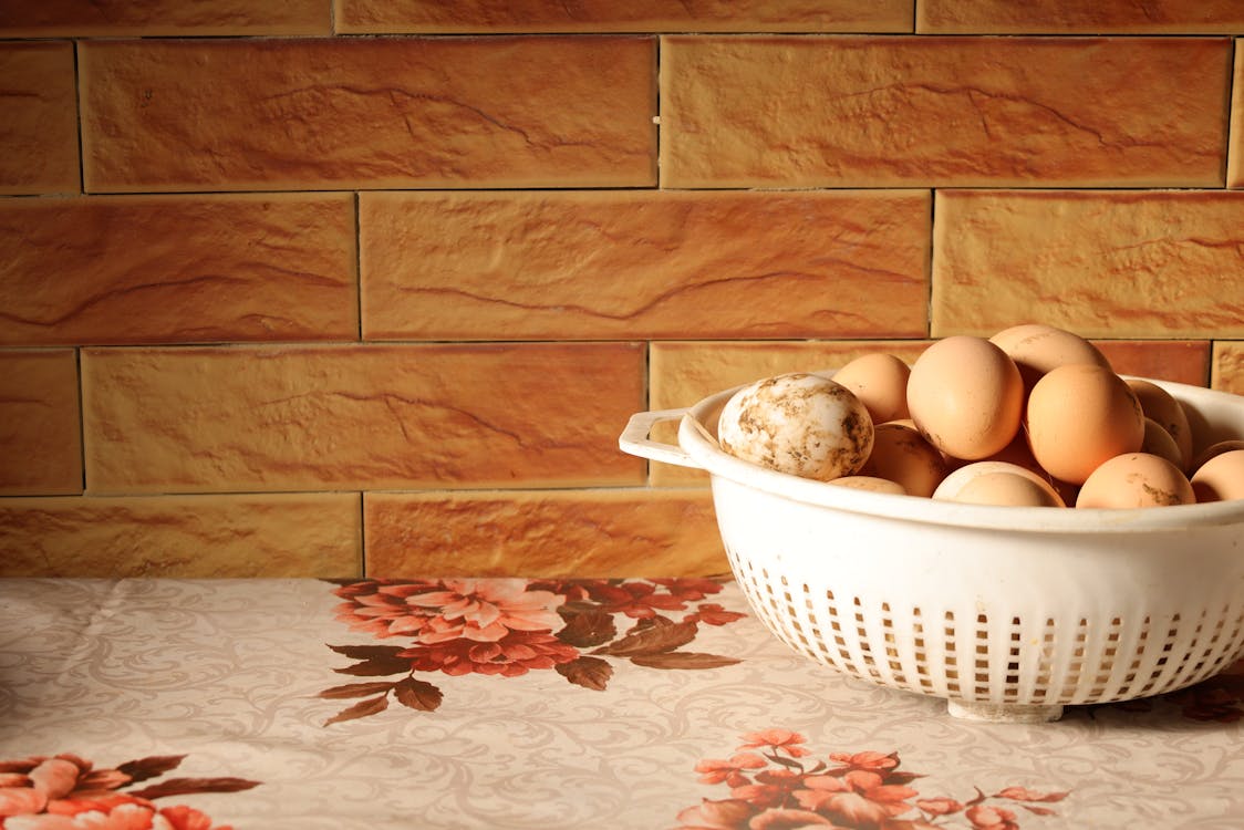 Pile of Eggs in a Colander in a Kitchen