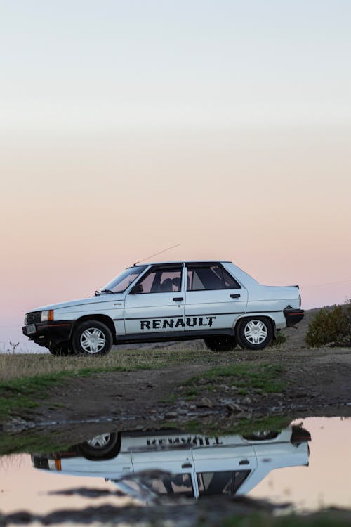 A Renault 9 Parked on a Field at Sunset