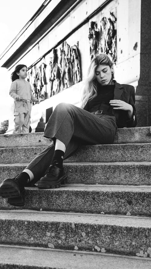 Model in Suit Sitting on Stairs in Black and White