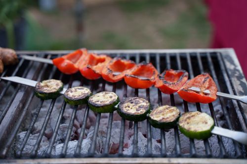 Free Close-up of fresh vegetables being grilled outdoors on a barbecue for healthy cooking. Stock Photo