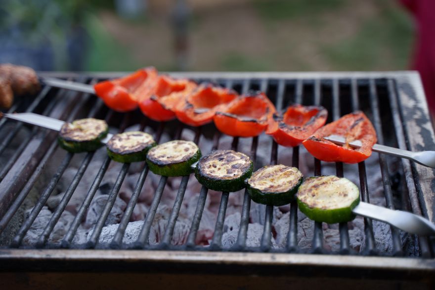 Grilled courgette and red pepper skewers over charcoal, photo by Boris Ivas on Pexels