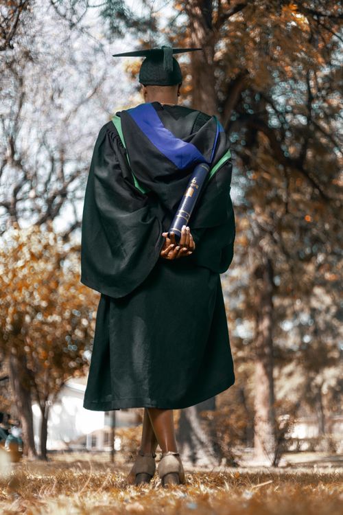 Woman in Graduation Gown and Mortarboard · Free Stock Photo