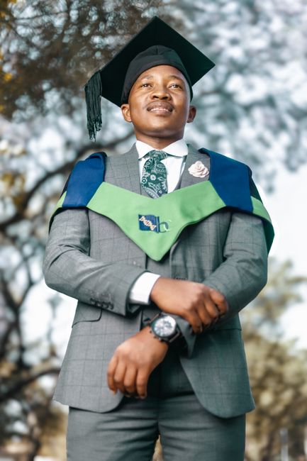 Young graduate in suit with mortarboard celebrating outdoors, showcasing academic achievement. Young graduate in suit with mortarboard celebrating outdoors, showcasing academic achievement.