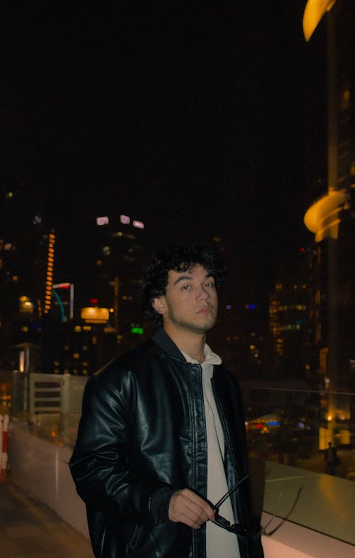 Man in Jacket in City at Night