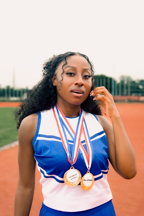 Sportswoman with Medals on a Running Track
