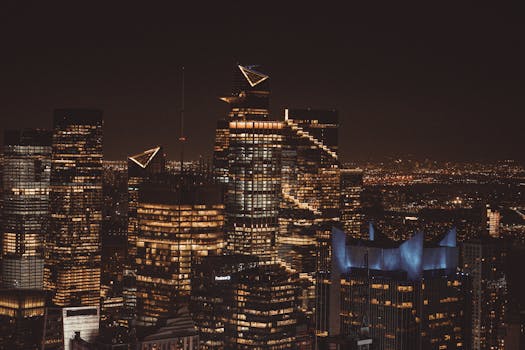 Stunning aerial view of New York City skyline at night, capturing illuminated skyscrapers.