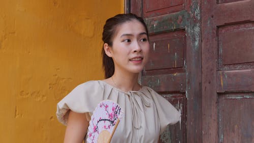 Young Brunette in Blouse with Embroidery