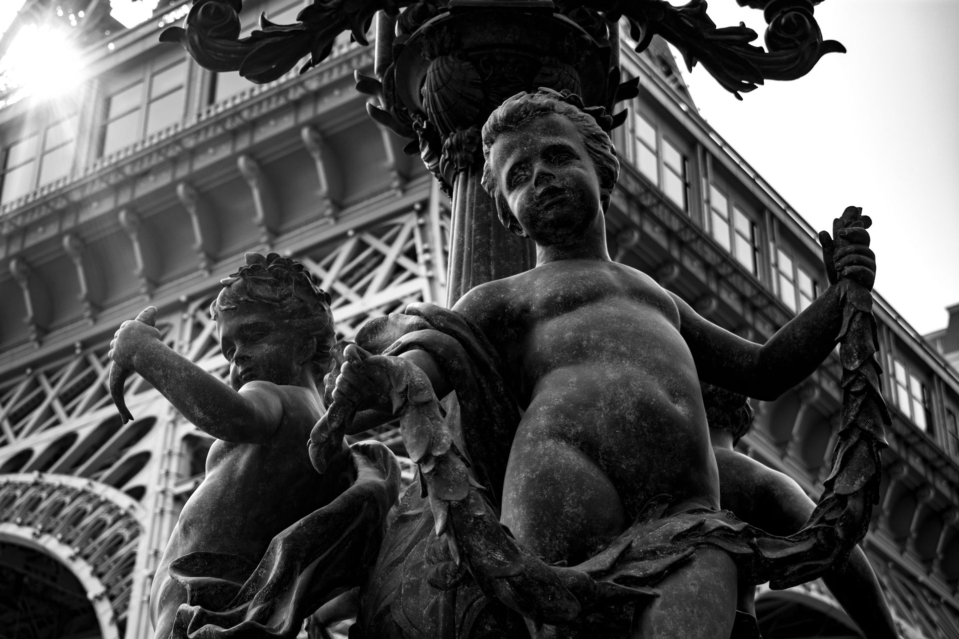 Bronze Sculptures of Children at the Base of the Lantern Near Eiffel Tower