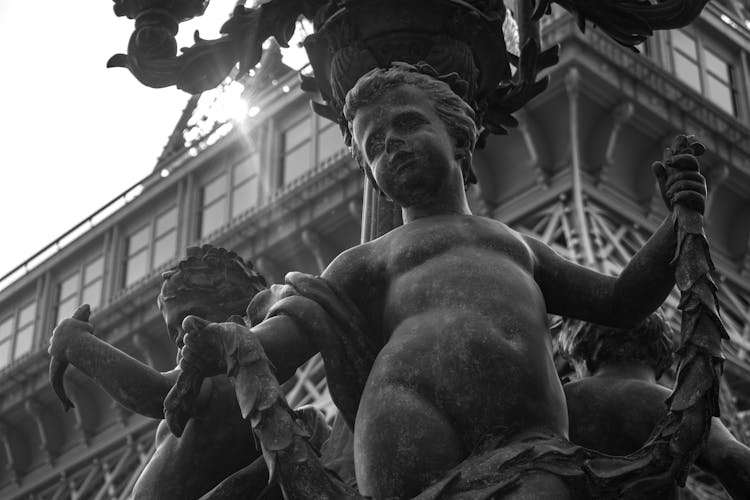 Boy Sculpture In Fountain In Black And White