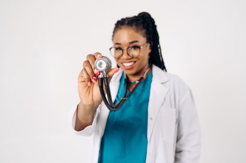 Free A cheerful female doctor with a stethoscope, promoting healthcare positivity. Stock Photo