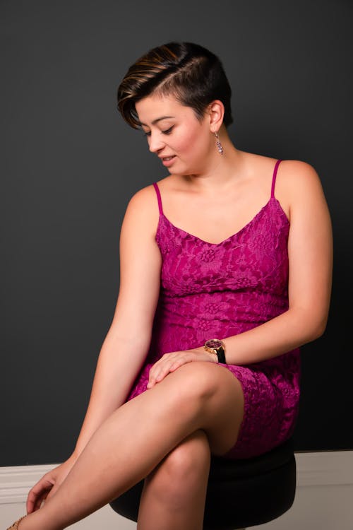 Woman Sitting in Pink Dress