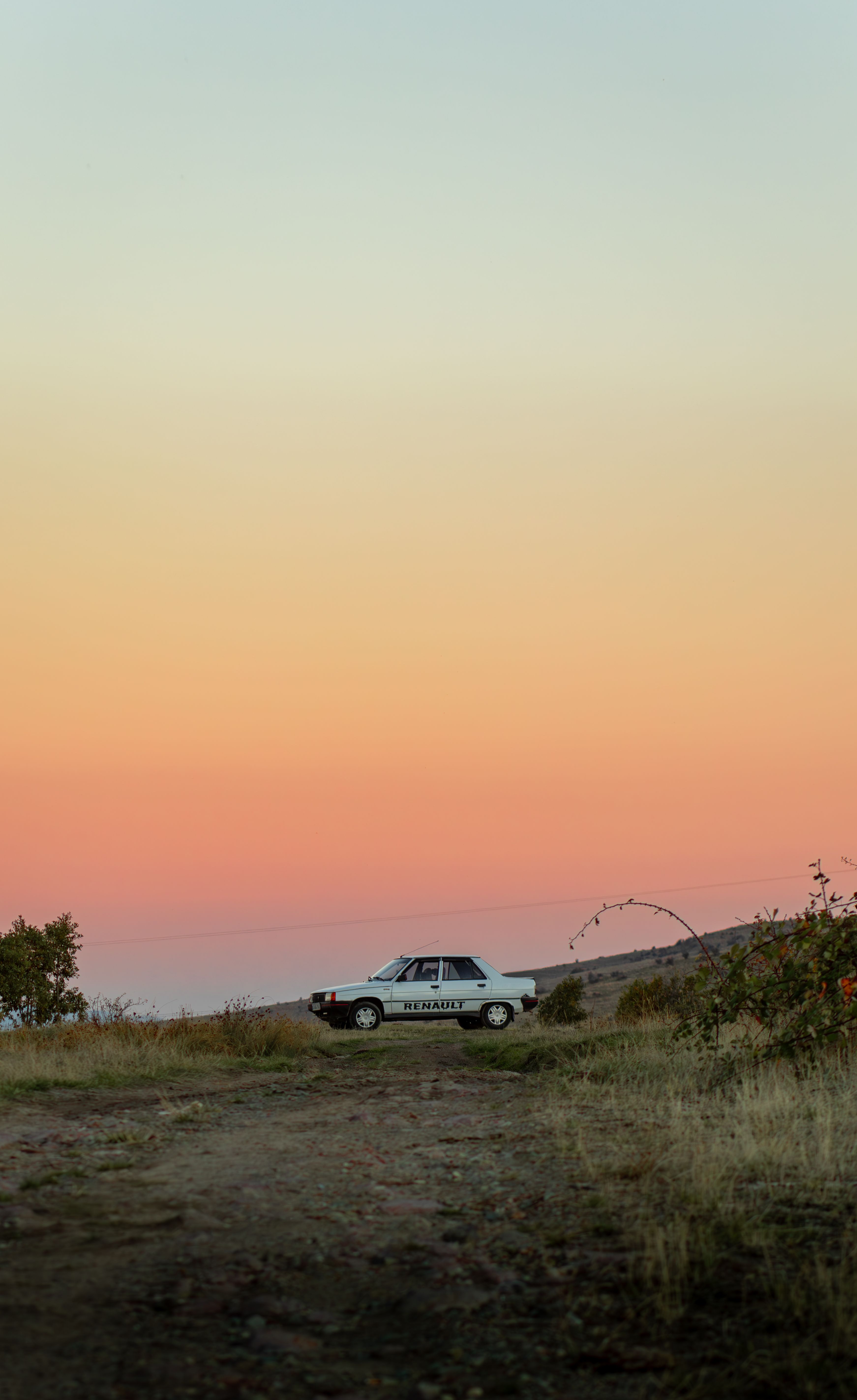 Car in a Field at Sunset · Free Stock Photo