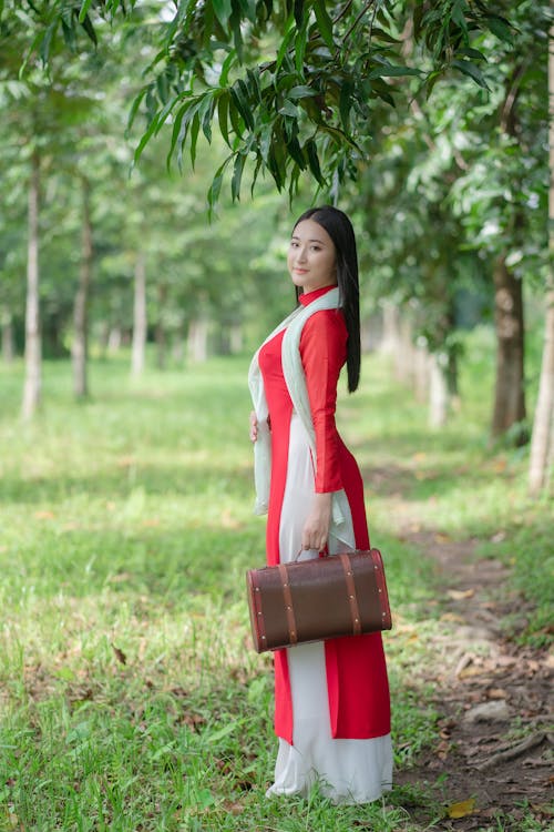 Woman in Traditional Clothing Standing with Bag