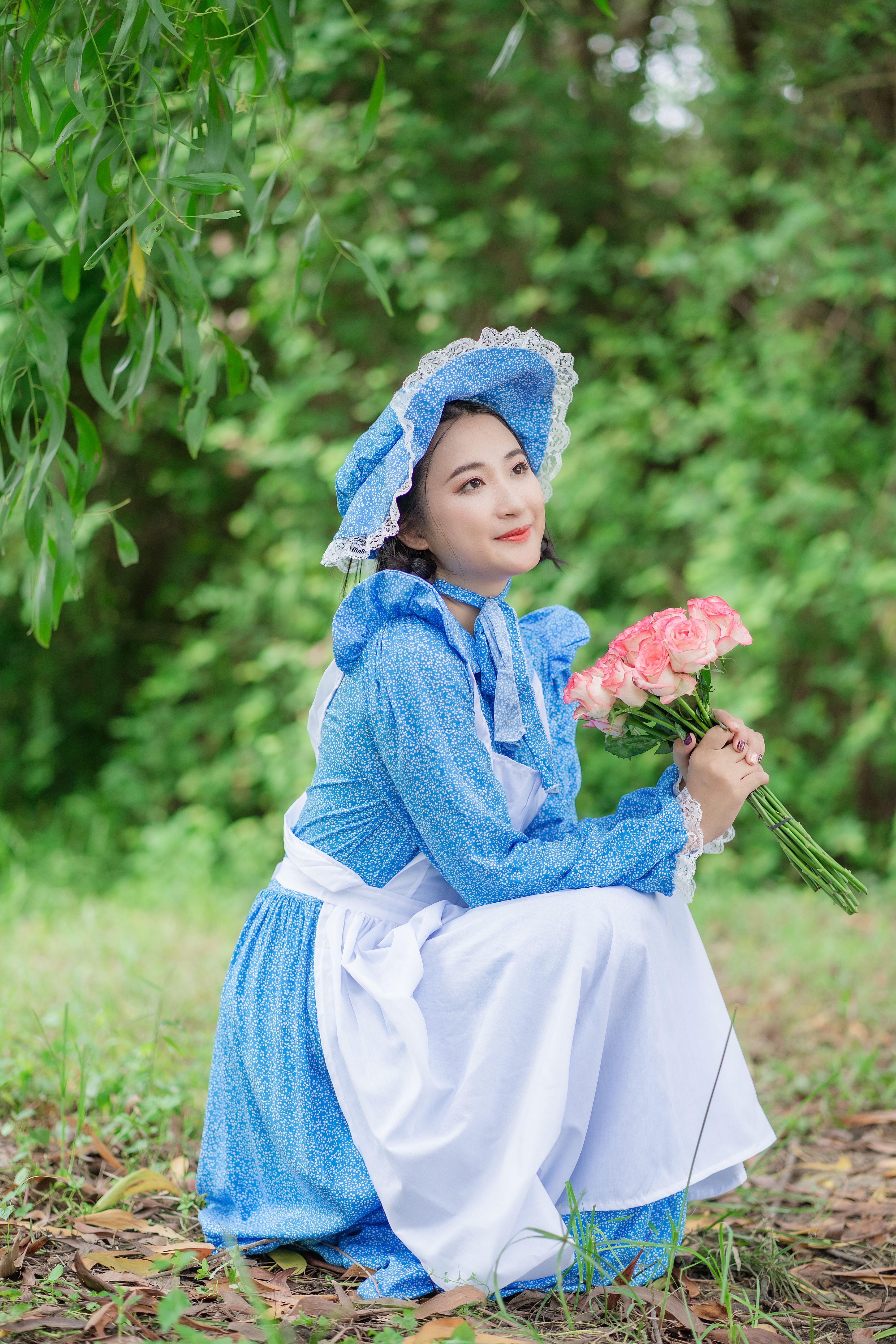 Woman Wearing Blue Dress Holding a Bouquet of Flowers · Free Stock Photo