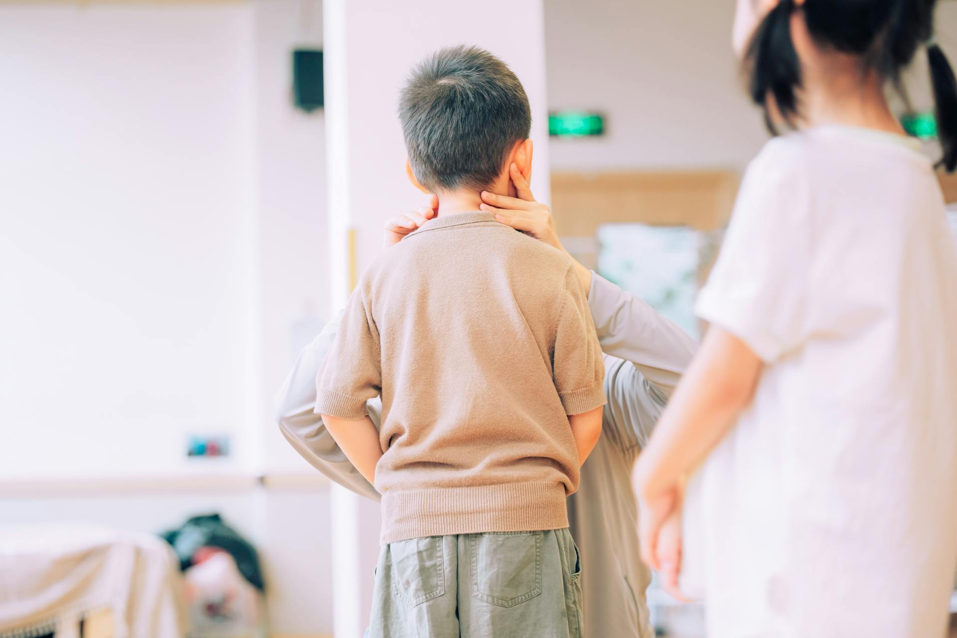 Young child being examined by a medical professional in a healthcare environment.