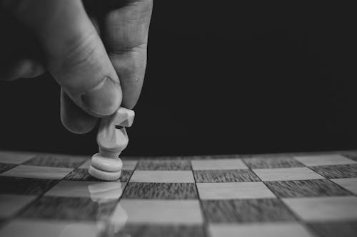 Free Close-up of a Person Moving a Pawn on a Chessboard Stock Photo