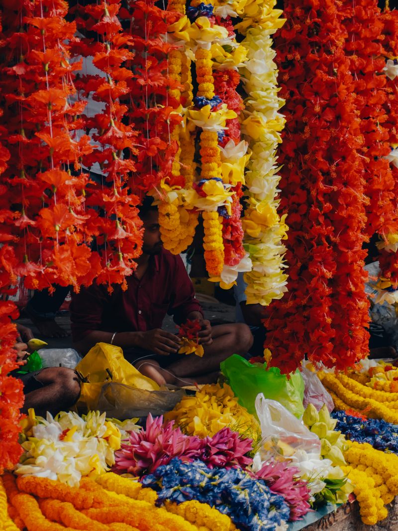 Marigold and flower garlands hanging at a market stall in Guwahati