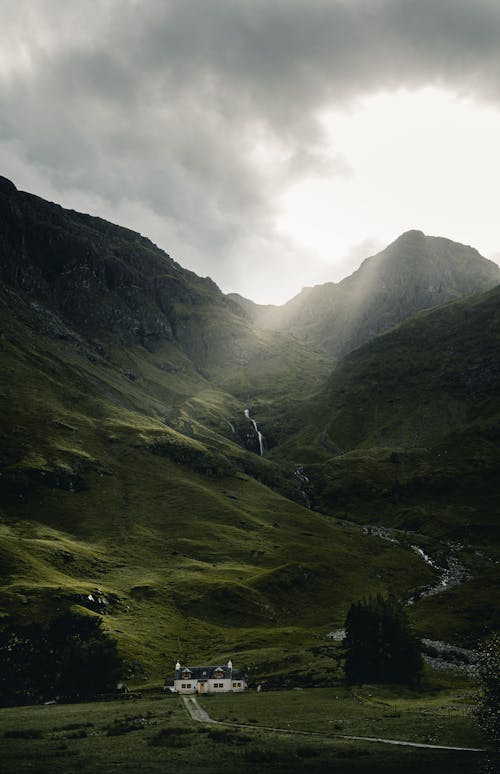 View of Mountains under a Cloudy Sky 