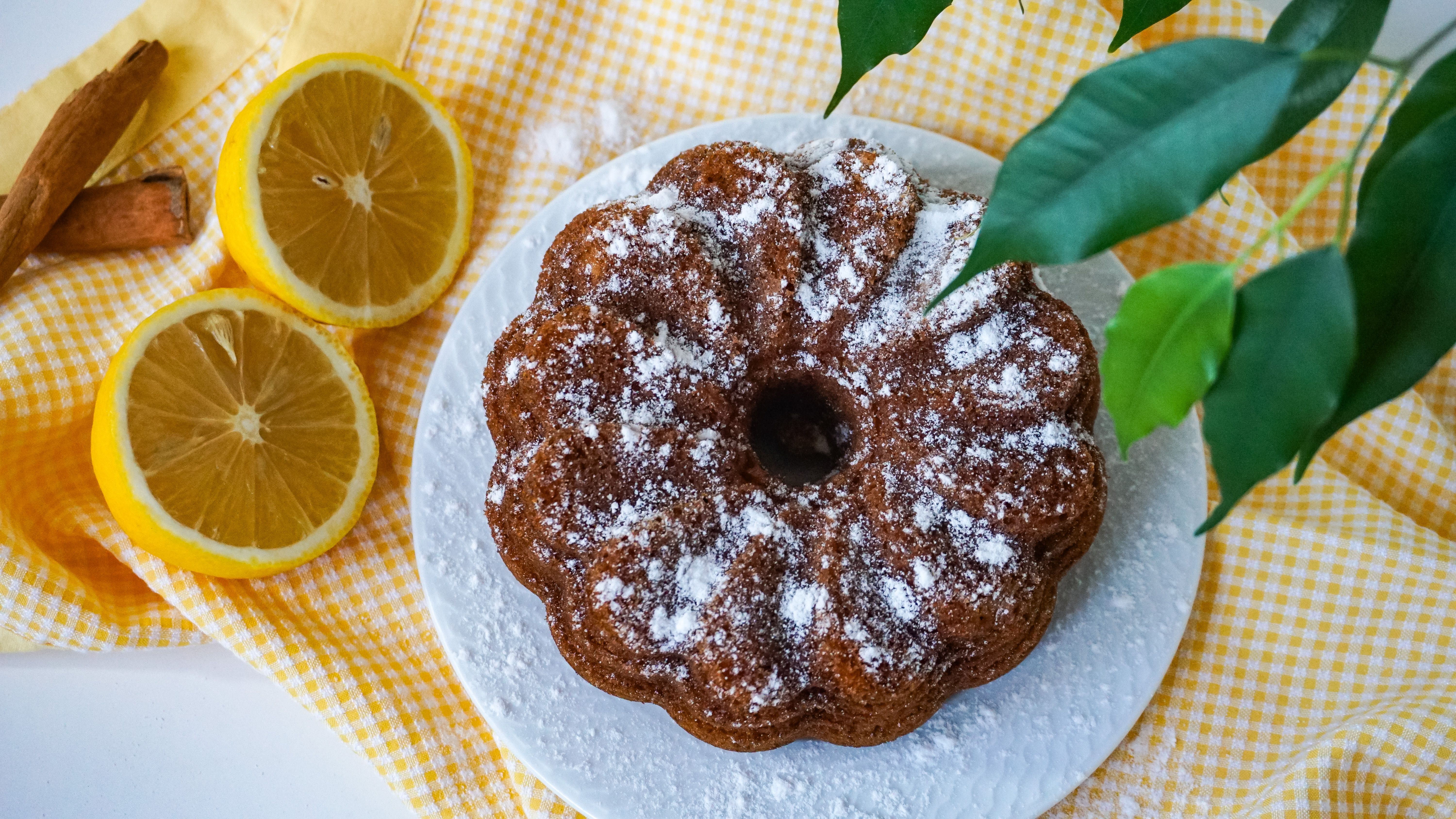 Loaf of lemon yogurt cake with lemon slices on top