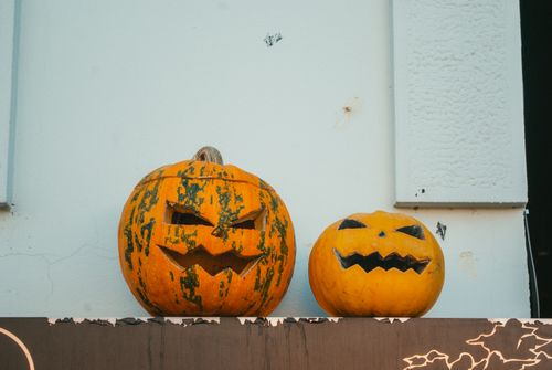 Free Close-up of two carved Halloween pumpkins with spooky faces. Stock Photo