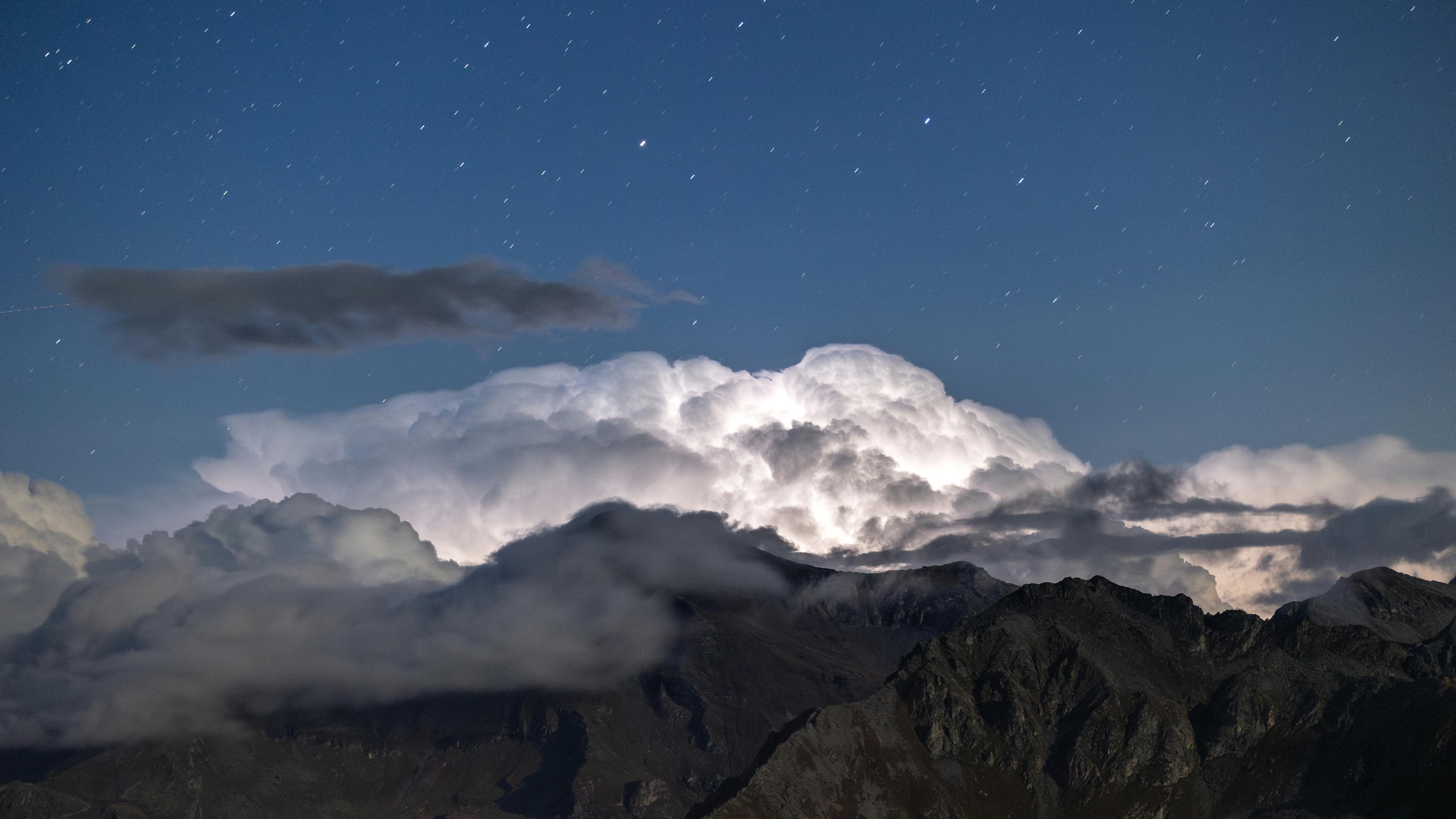 Prescription Goggle Inserts - Stunning nighttime mountain scene with clouds and stars creating a magical landscape.