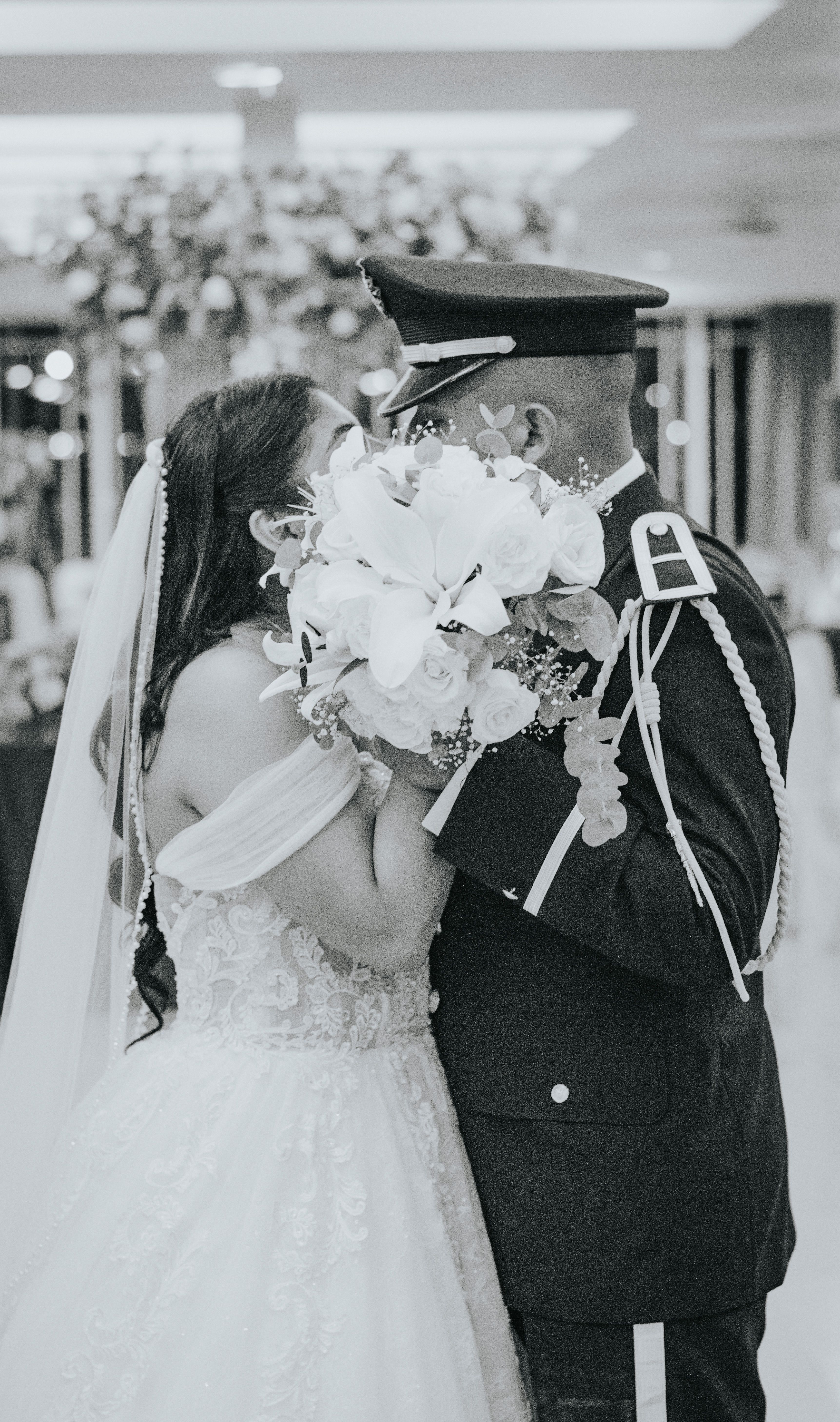 A couple shares a loving kiss during their wedding, highlighting romance and unity.