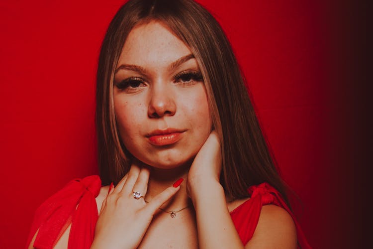 Portrait Of Brunette Woman In Red Background