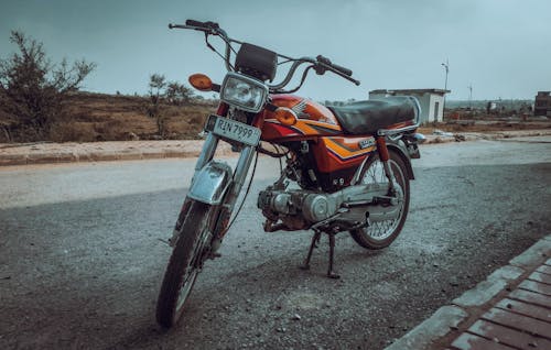 A Vintage Honda Motorcycle on a Street 