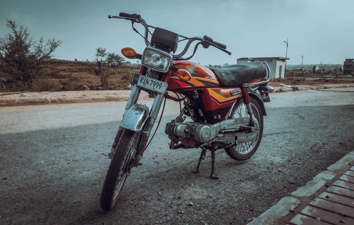 A Vintage Honda Motorcycle on a Street 