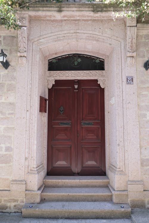 Wooden Door in a Building with Carved Details on the Facade