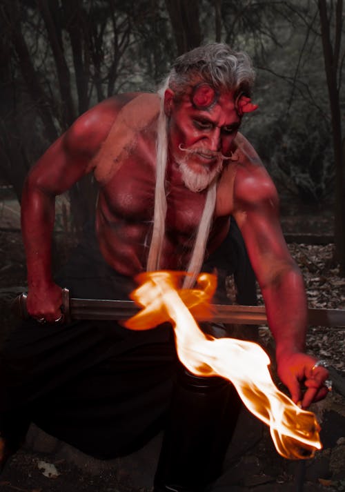 Devil Holding Sword over Fire