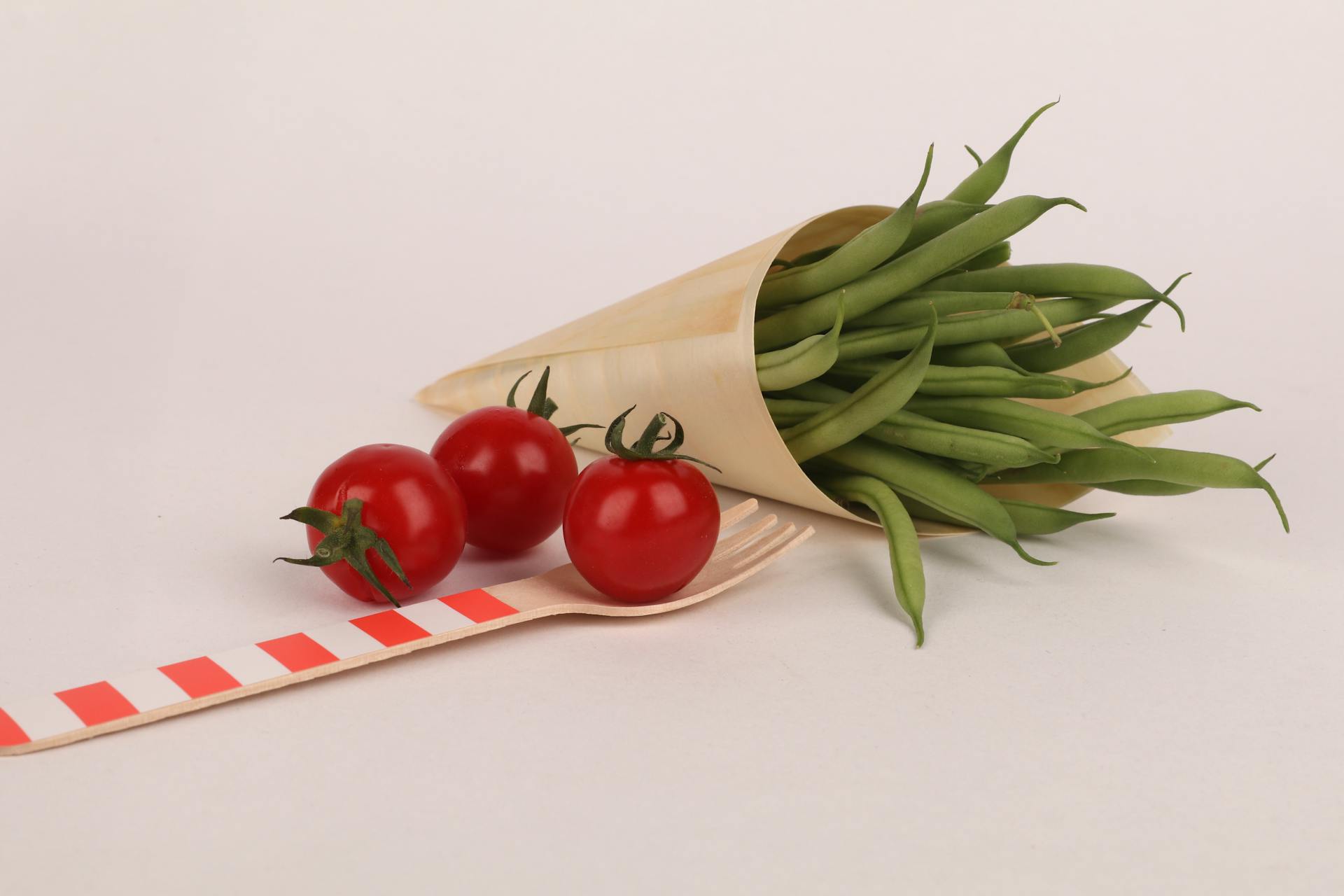 Red Cherry Tomatoes and Green Beans Wrapped in a Paper Cone