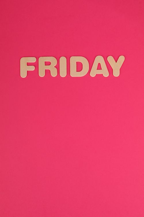 Free Bold 'Friday' sign on vibrant pink background offering ample copy space. Stock Photo