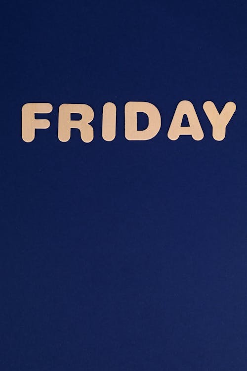 Free Friday Word on Navy Blue Background Stock Photo