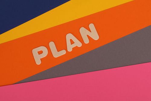 Free Vibrant geometric colored background with the word 'Plan' in bold letters, perfect for business concepts. Stock Photo