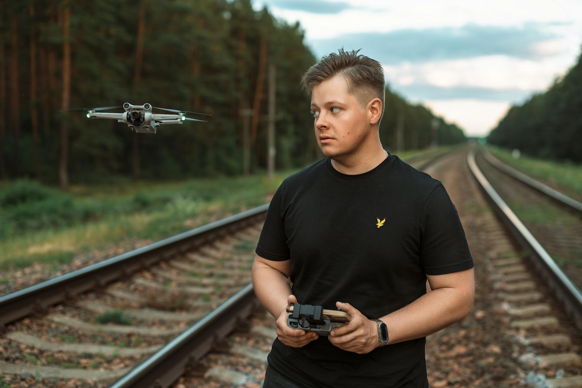 Drone Pilot on Railway Tracks in the Forest