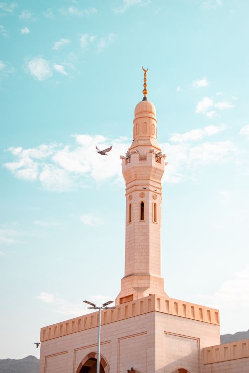 Free A stunning view of a mosque minaret in Medina, showcasing Islamic architecture under a clear blue sky. Stock Photo
