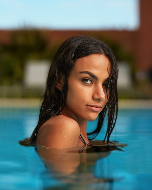 Young Woman Posing in a Swimming Pool 