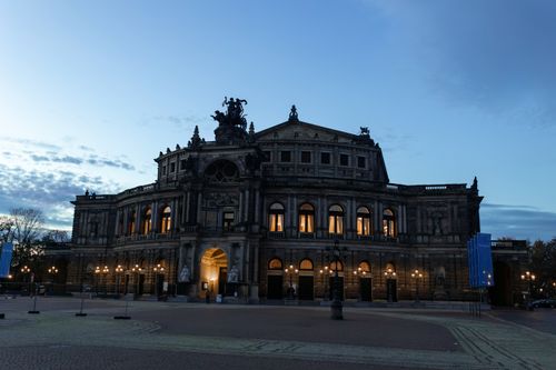 Free The majestic Semperoper in Dresden, Germany at dusk, beautifully illuminated against the evening sky. Stock Photo