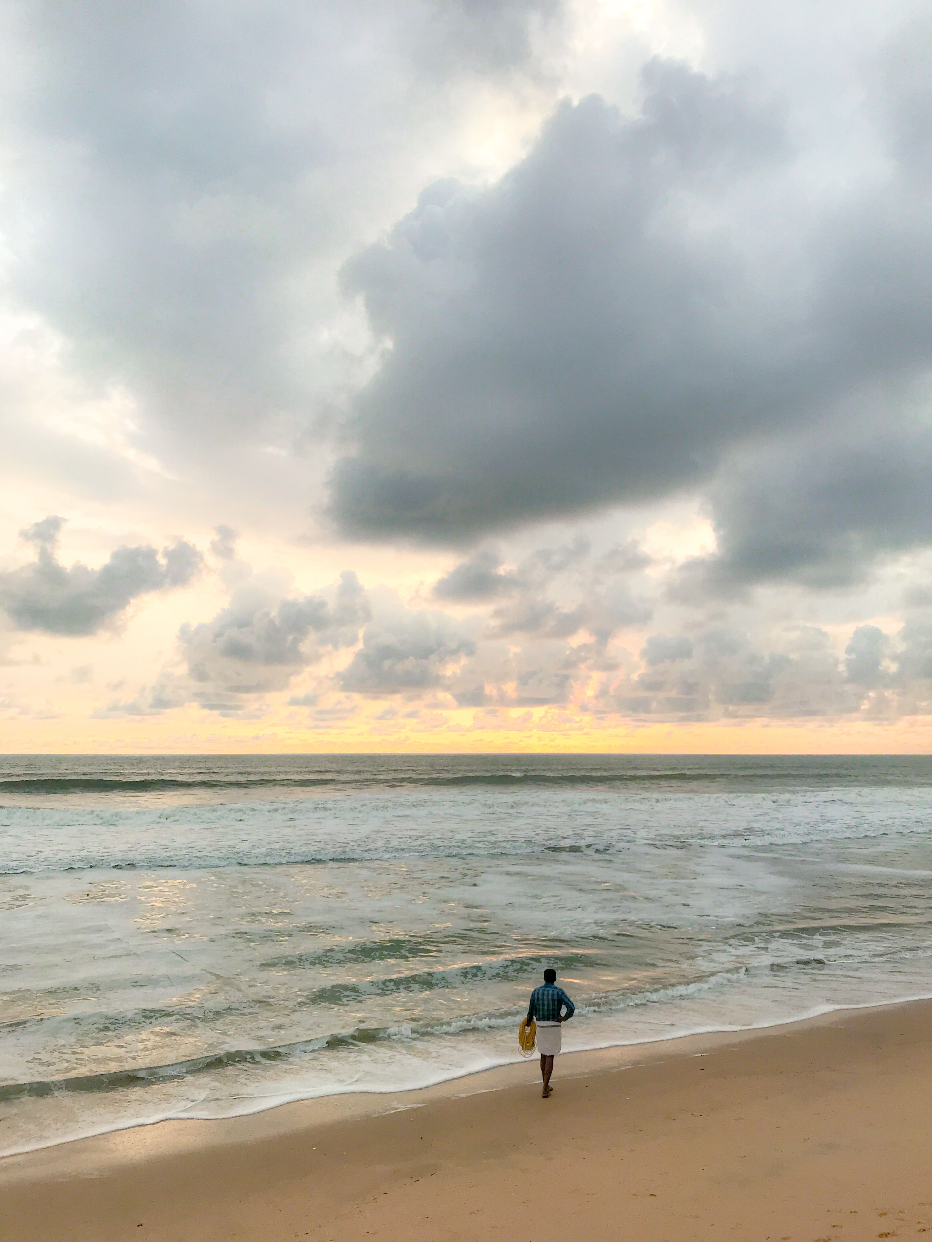 A Person Walking Alone on the Beach at Sunset · Free Stock Photo