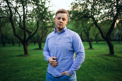 Man in a Blue Plaid Shirt in the Orchard