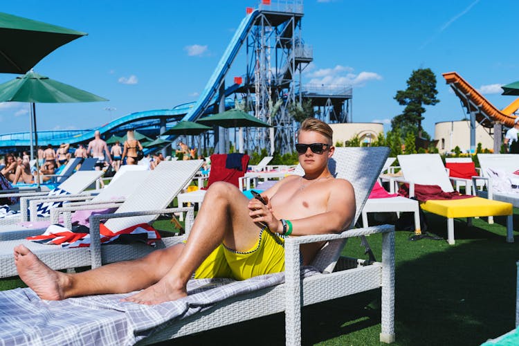 Man Lying On Sunlounger And Sunbathing