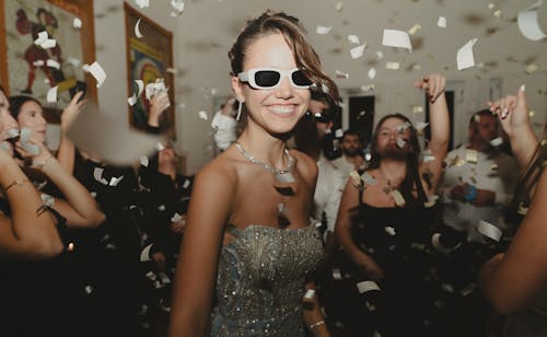 Free Confetti Falling on People Having Fun during a Party Stock Photo