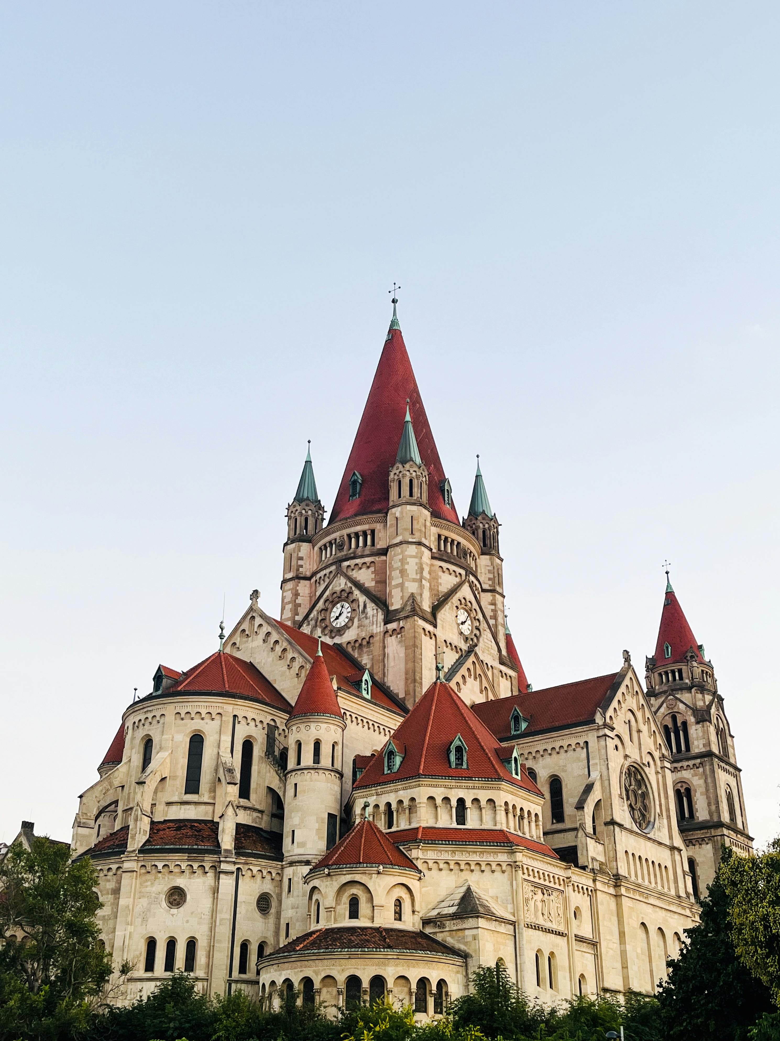 St. Francis of Assisi Church with iconic red roof against a clear sky in Vienna, Austria.