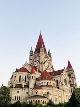 St. Francis of Assisi Church with iconic red roof against a clear sky in Vienna, Austria.