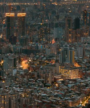A breathtaking aerial view of a vibrant cityscape illuminated at night, showcasing modern architecture and skyscrapers.