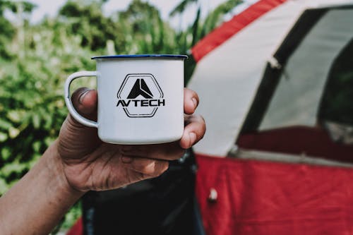 Person Holding White Avtech Cup